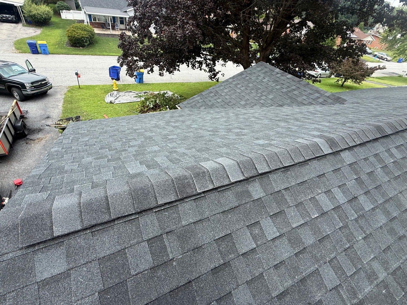 Aerial view of new grey architectural shingles showing crisp ridge and hip lines