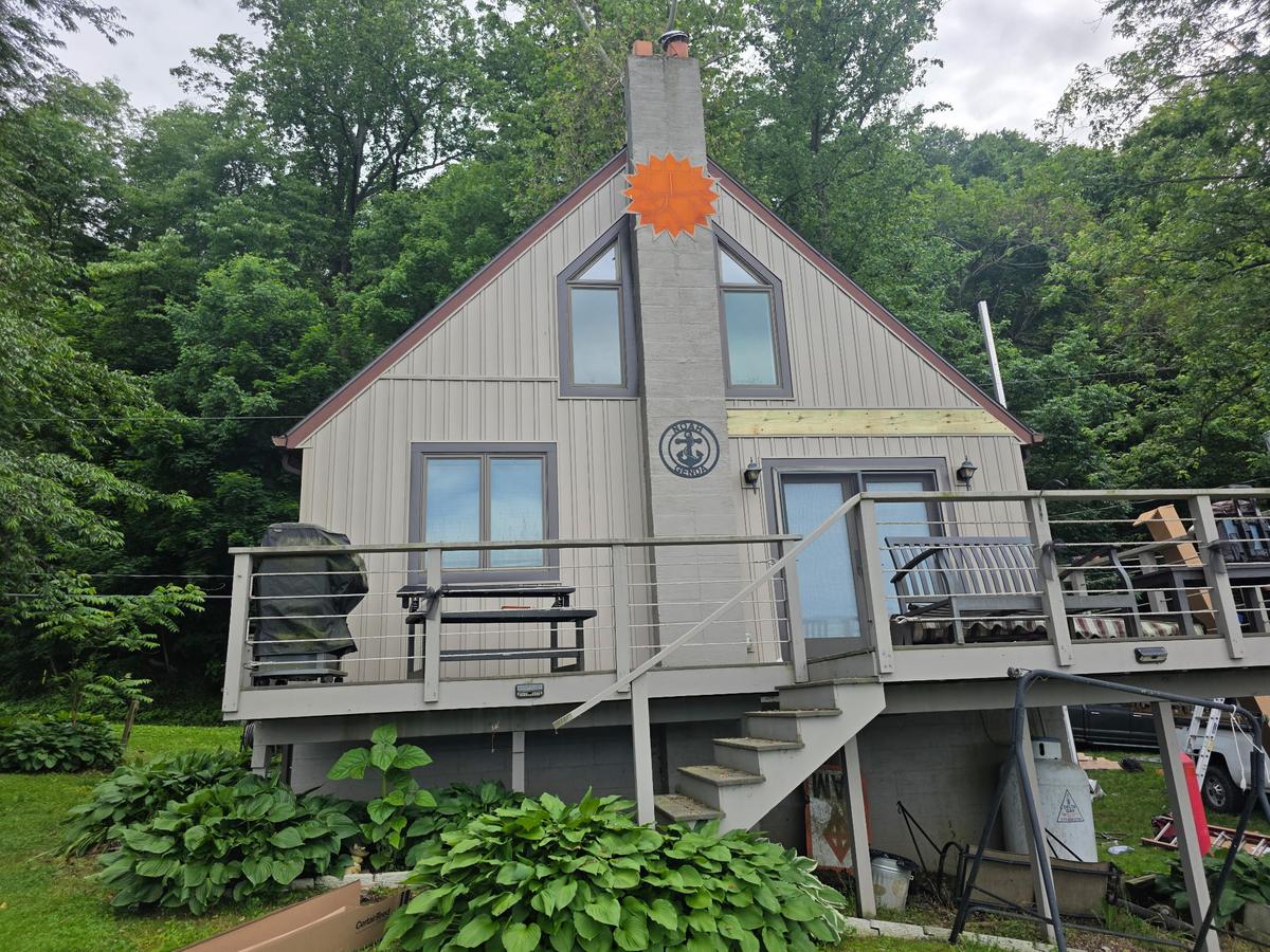 Lakeside cottage with a new architectural shingle roof installed by Dallastown Roofing