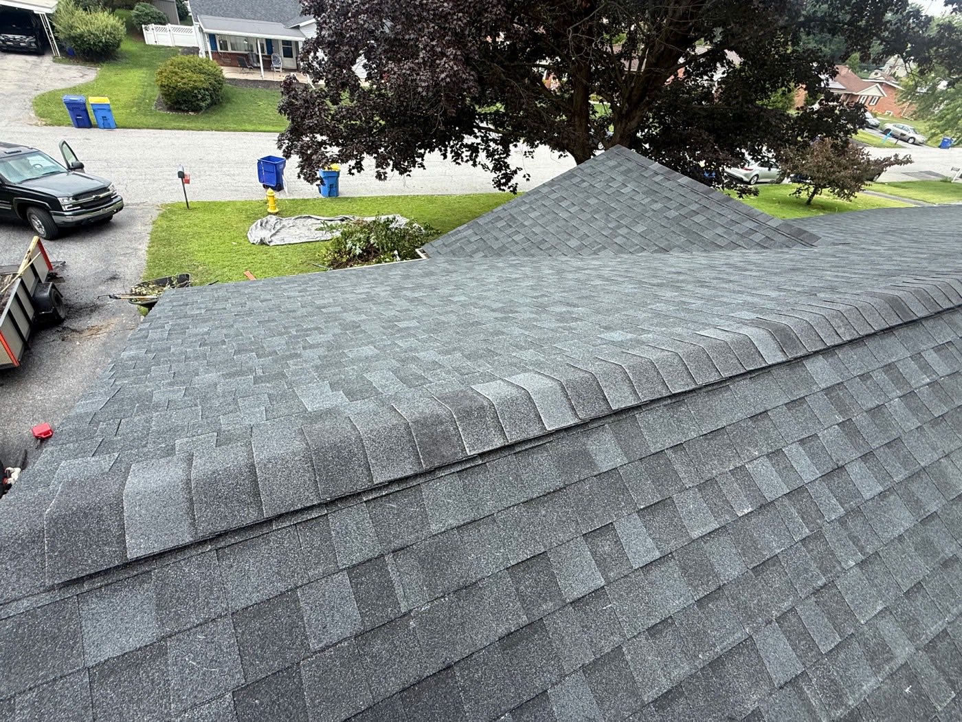 Aerial view of new grey architectural shingles showing crisp ridge and hip lines