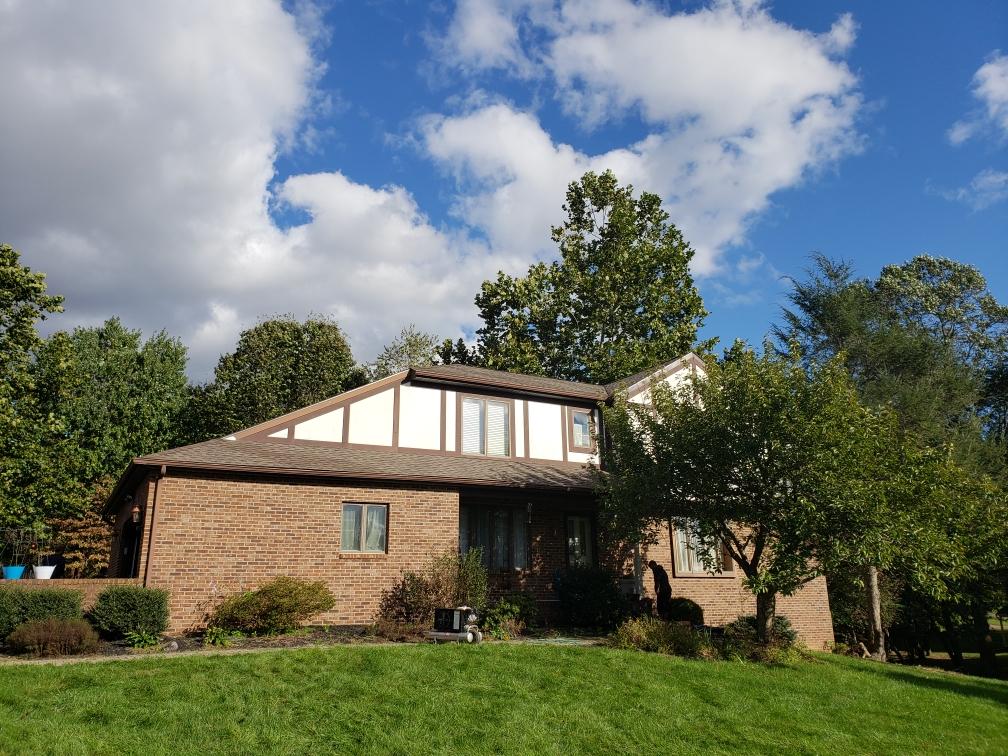 Tudor-style home with a new tan architectural shingle roof